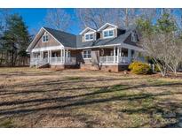 Two-story home with wraparound porch and landscaped yard at 3044 Old Church Rd, Gastonia, NC 28052