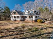 Charming two-story home with a welcoming porch, manicured lawn, and beautiful landscaping at 3044 Old Church Rd, Gastonia, NC 28052