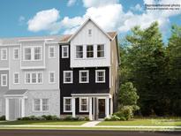 3-story townhome with black and white exterior, 2-car garage, and grassy lawn at 4076 Skyboat Cir, Fort Mill, SC 29715