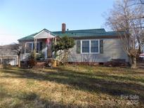 Charming one-story house with green metal roof and landscaped yard at 419 Dallas Stanley Hwy, Dallas, NC 28034