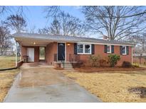 Charming single-story brick home with a covered carport and well-maintained front yard at 901 Wyke Rd, Shelby, NC 28150