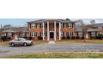 Brick building with columns, landscaping, and ample parking at 904 Mcalway Rd # B, Charlotte, NC 28211