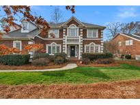 Stately brick home featuring classic architectural details, manicured landscaping, and a welcoming front entrance at 10417 Sutherby Dr, Charlotte, NC 28277