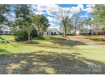 Inviting white home featuring a well-manicured lawn and a classic design with black shutters at 1139 Hermitage Rd, Rock Hill, SC 29732