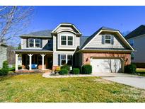 Charming two-story home with brick accents, a well-manicured lawn, and an attached two-car garage at 162 Misty Woods Dr, Lake Wylie, SC 29710