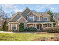 Charming two-story brick home with landscaped yard and inviting front porch at 1806 Grayscroft Dr, Waxhaw, NC 28173