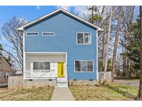 Charming two-story home featuring a bright yellow door and modern blue siding at 2100 St Paul St, Charlotte, NC 28216