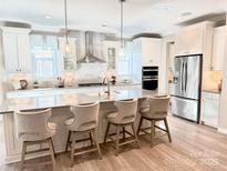 Spacious kitchen with island, stainless steel appliances, and white cabinetry at 2108 Cadence Trace Dr, Mint Hill, NC 28227