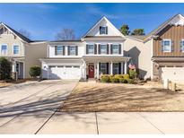 Charming two-story home features a well-maintained lawn and a two-car garage at 223 Blossom Ridge Dr # 137, Mooresville, NC 28117