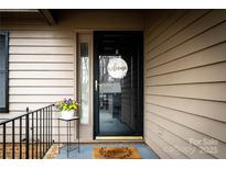 Inviting front entrance with a decorative 'welcome' wreath and flower decor at 2710 Redbud Ln, Fort Mill, SC 29715