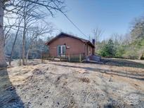 Charming cabin featuring a cozy front porch and a serene, wooded setting at 3609 Shillinglaw Rd, Sharon, SC 29742