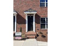 Brick townhouse with a black front door and small steps leading to the entrance at 451 Beacon Nw St # 6, Concord, NC 28027