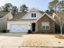 Charming single-Gathering home boasts a stone accent, two-car garage, and manicured lawn at 577 Rustlewood Way, Rock Hill, SC 29732