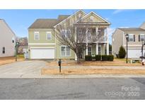 Charming two-story home features a welcoming porch, attached garage, and well-maintained landscaping at 8312 Compton Acres Ln, Waxhaw, NC 28173