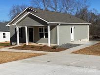 Gray house with a front porch and small yard at 1027 Adams St, Statesville, NC 28677