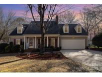 Charming one story home with covered front porch, front yard and attached garage at 11918 Parks Farm Ln, Charlotte, NC 28277