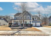 Charming two-story home with a welcoming front porch and a well-manicured lawn, perfect for suburban living at 1412 Great Rd, Waxhaw, NC 28174