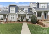 Charming townhome with a well-manicured lawn and inviting walkway at 14955 Alexander Place Dr, Huntersville, NC 28078