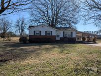 Brick ranch house with carport and mature trees at 1674 Fallston Rd, Shelby, NC 28150