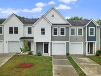 Two-story townhome with gray and white exterior, two-car garage, and landscaped lawn at 215 Briana Marie Way, Indian Trail, NC 28079