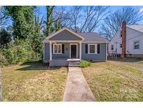 Charming home featuring a cute front porch, neat landscaping, and an inviting walkway at 3138 Morson St, Charlotte, NC 28208