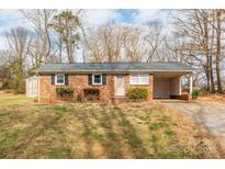 Brick ranch house with carport and storage shed at 3301 10Th Ne Ave, Conover, NC 28613