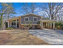 Charming two-story home with a gray exterior, brick accents and a covered portico at 3723 Annlin Ave, Charlotte, NC 28209