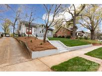 Gray craftsman home on a tree-lined street with a manicured lawn at 423 W Bell St, Statesville, NC 28677