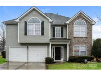 Two-story house with gray siding, stone accents, and a two-car garage at 675 Winding Branch Rd, Rock Hill, SC 29732