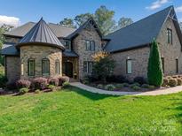 Stone and brick home with a metal roof and landscaping at 7672 Nautical Vw, Denver, NC 28037