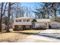 Ranch style home with a brick facade and attached garage at 7716 Elwood Dr, Charlotte, NC 28227