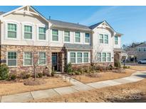 Townhome features stone and siding exterior, and landscaping at 1412 Galloway Rd, Charlotte, NC 28262