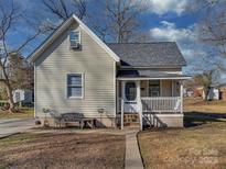 Charming yellow house with white porch and landscaping at 210 Goff St, Charlotte, NC 28208