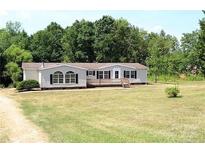 Charming single-story home with a spacious front yard and a welcoming front porch, perfect for outdoor relaxation at 314 Flowering Tree Ln, Rockwell, NC 28138
