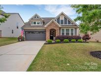 Charming home with stone accents, well-manicured lawn, and an attached two-car garage at 4929 Norman Park Pl, Clover, SC 29710