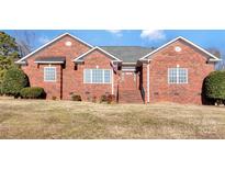 Brick ranch house with landscaped lawn and attached garage at 509 Mcmillan Dr, Indian Trail, NC 28079