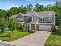 Two-story home with gray siding, two-car garage, and landscaped yard at 6029 Landry Ln, Indian Land, SC 29707