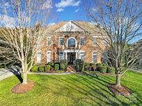 Beautiful brick home boasts a manicured lawn and mature trees in a peaceful neighborhood at 8011 S Dorchester Trce, Indian Land, SC 29707