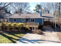 Updated blue house with deck and driveway at 22013 Torrence Chapel Rd, Cornelius, NC 28031