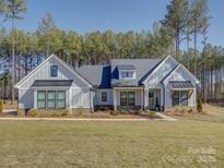 Charming single-story home featuring board and batten siding and a welcoming front porch at 2396 Lee Lawing Rd, Lincolnton, NC 28092