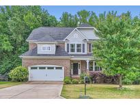 Charming two-story home with a brick facade, attached garage, and well-manicured front yard at 2864 Park Ridge Blvd, Rock Hill, SC 29732