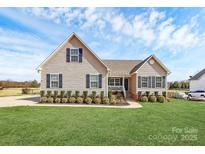 Charming home featuring tidy landscaping, complementing the light-colored exterior with black shutters at 332 Shiloh S Rd, York, SC 29745