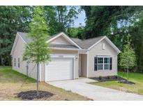 Charming single-Gathering home featuring a one-car garage and well-maintained landscaping at 406 Killian Ave, Mount Holly, NC 28120