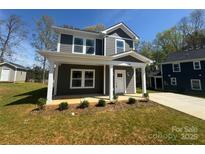 Charming new two-story home with a welcoming front porch and manicured lawn at 548 Geneva Cir, Gastonia, NC 28056