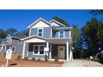 Charming two-story home showcasing a covered front porch, white trim, and a neatly landscaped yard at 601 Bentbrush Dr, Gastonia, NC 28056