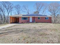 Brick ranch house with solar panels and carport at 720 Pleasant Ave, Kannapolis, NC 28081