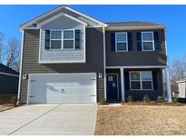 Charming two-story home featuring a spacious garage, a well-manicured lawn, and beautiful curb appeal at 214 Brinkley Dr, Kings Mountain, NC 28086