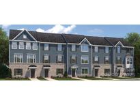 Charming new townhome features brick accents, complementary shutters, and covered entryway at 434 Serenity Cir # F, Cramerton, NC 28032