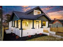 Charming renovated bungalow with a white brick facade and a welcoming front porch at 49 8Th Se St, Hickory, NC 28602