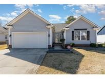 Charming single-story home featuring a one car garage and manicured lawn at 9415 Melanie Thompson Dr, Charlotte, NC 28213